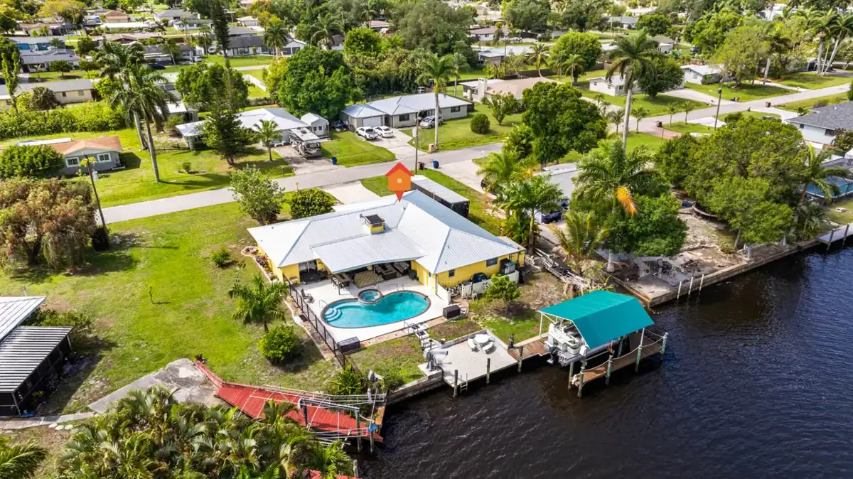 Aerial view of 147 Coral Drive, pool, dock and covered boat lift on a Morse Shores canal