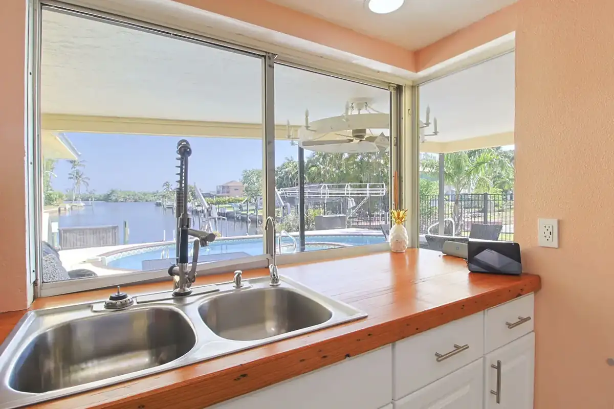 Kitchen sink window looking out to the pool and canal